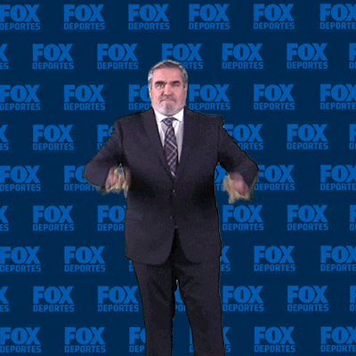 a man giving a thumbs up in front of a wall that says fox deportes