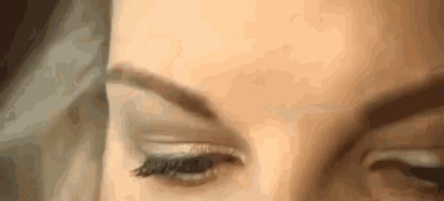 a close up of a woman 's eye with long eyelashes