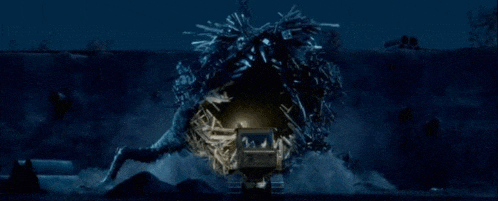 a giant monster is coming out of a hole in the ground .