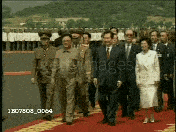 a group of people walking on a red carpet with the number 1b07808_0064 on the bottom right