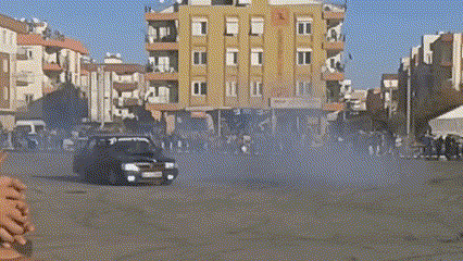 a car driving down a street with the word megnum written on the bottom