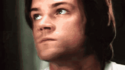 a close up of a man 's face with his eyes closed .