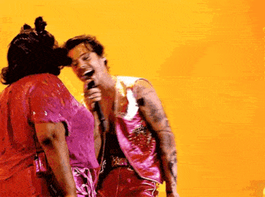 a man and a woman are standing next to each other on a stage .