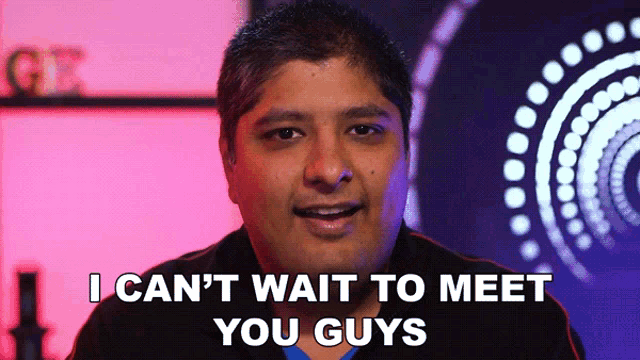 a man says " i can 't wait to meet you guys " in front of a colorful background