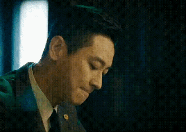 a man in a suit and tie is making a funny face