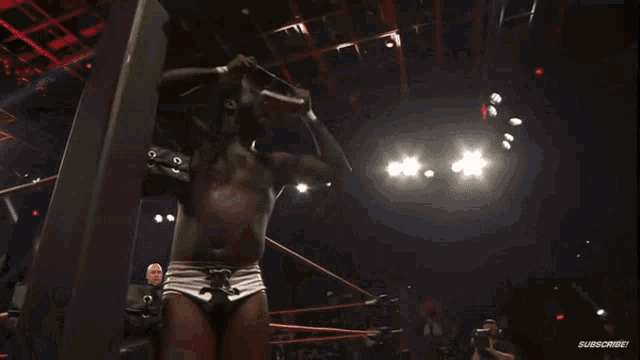a man with dreadlocks is in a wrestling ring with a subscribe button on the bottom right