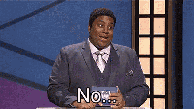 a man in a suit and tie is standing in front of a podium and holding a sign that says no .