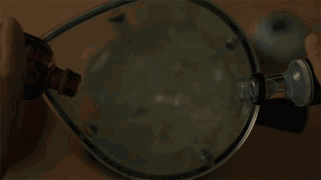 a person is pouring liquid into a blender