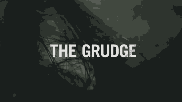 a dark background with the words the grudge in white