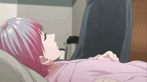 a girl with pink hair is laying down in a bed