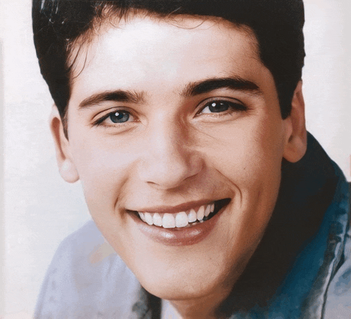 a close up of a man 's face smiling