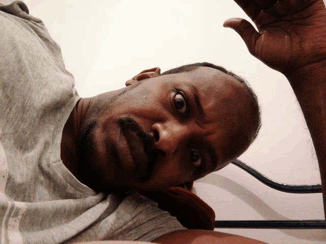 a man with a beard and mustache is laying on a bed