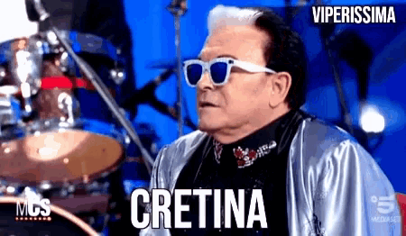 a man wearing sunglasses says cretina in a video