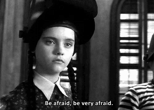 a black and white photo of a girl saying be afraid