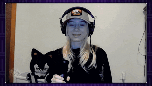 a woman wearing headphones and a hat that says ' wizard ' on it