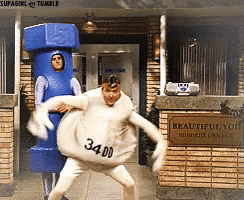 a man in a nut costume stands next to a man in a white costume with the number 34.00 on it