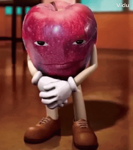 a cartoon apple with arms and legs is sitting on the floor with his hands folded .