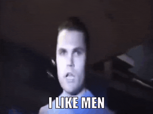 a man in a blue shirt is making a funny face and saying i like men .