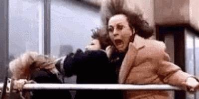 a woman is screaming while standing next to a railing .