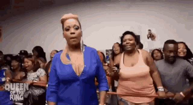 two women are standing next to each other in front of a crowd .