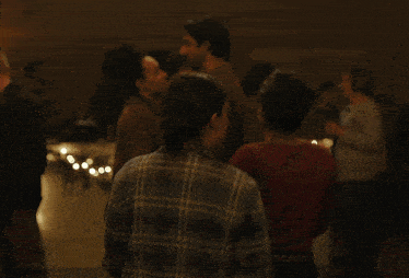a blurry picture of a person 's face with a few other people in the background