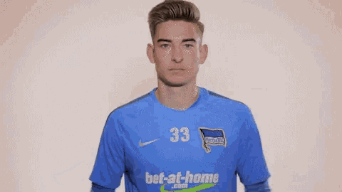 a soccer player wearing a blue jersey with the number 33 on it