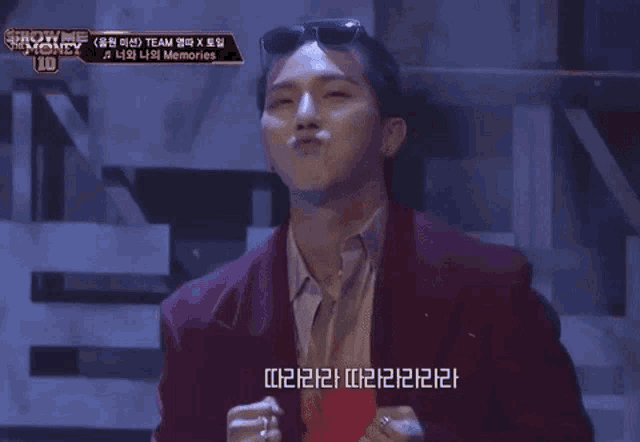 a man wearing sunglasses and a red jacket is making a funny face