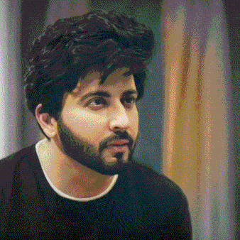 a man with a beard wearing a black shirt looks at the camera