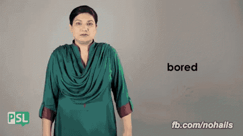a woman in a green dress is making a bored sign