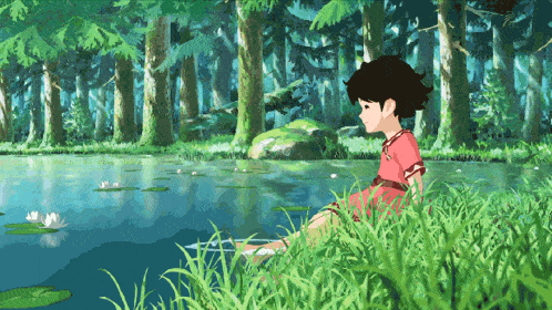 a girl in a red dress sits in the grass near a pond