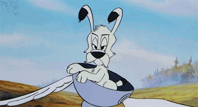 a cartoon character is sitting in a bowl