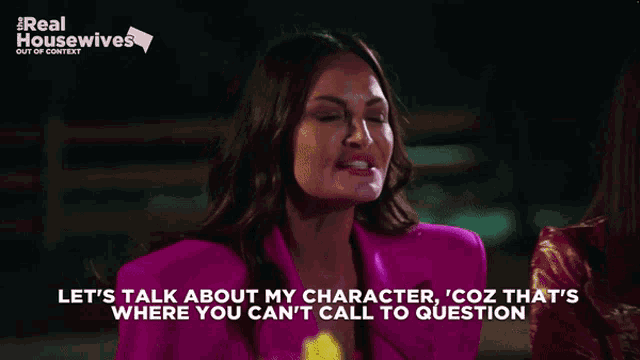 a woman in a pink jacket is talking about her character