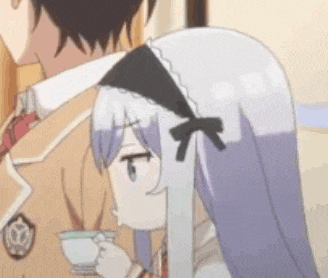 a girl with a bow on her head is drinking from a cup .
