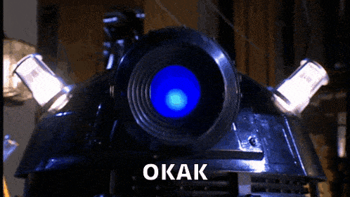 a close up of a robot 's head with the word okak on the bottom