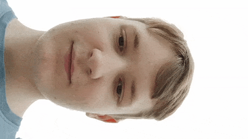 a close up of a young man 's face with a white background