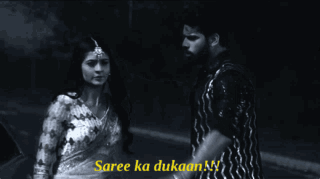 a black and white photo of a man and woman with the caption saree ka dukaan !!