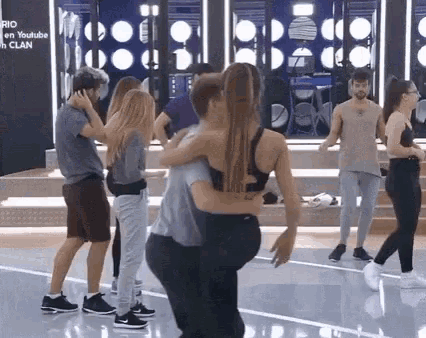 a group of people are dancing in a room with a sign that says youtube on it .