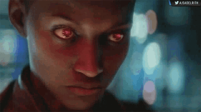 a close up of a person 's face with red eyes and a twitter logo