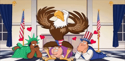 a bald eagle is sitting on the statue of liberty 's feet