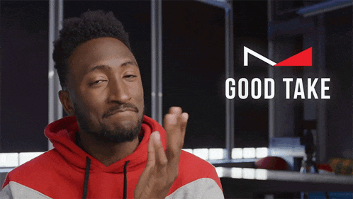 a man in a red hoodie is giving a thumbs up in front of a good take logo