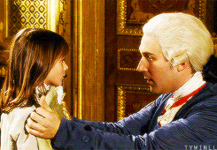 a man in a wig is holding a little girl