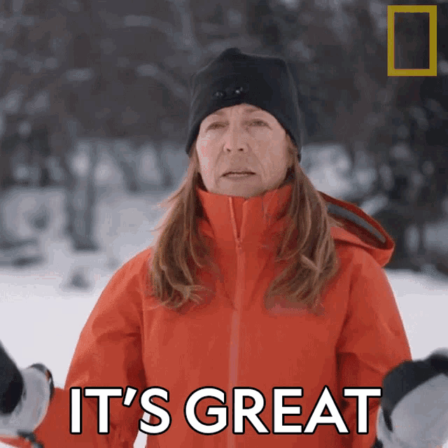 a woman wearing a red jacket and a black hat says it 's great