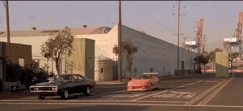 a car is driving down a street with a stop sign