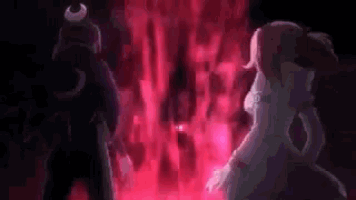 a man and a woman are standing in front of a red fire .