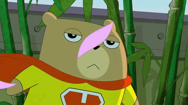 a cartoon bear wearing a yellow shirt with the letter t on it is standing in a bamboo forest