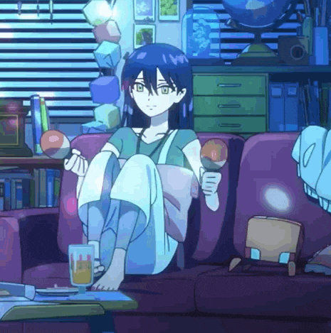 a girl is sitting on a couch holding a ball