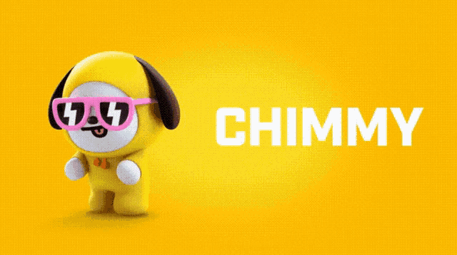 a stuffed animal with a yellow hat and black ears is sticking out its tongue