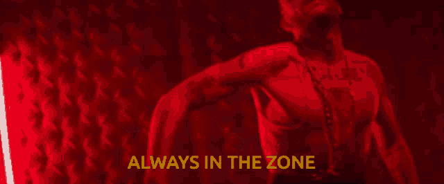 a man without a shirt is in a dark room with the words always in the zone above him