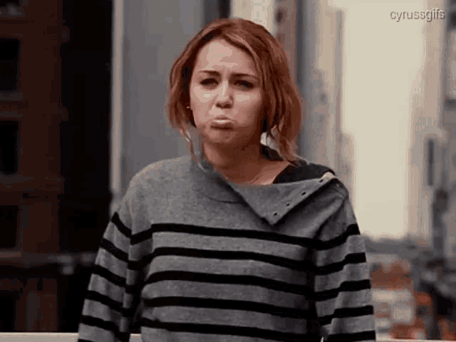 a woman in a striped sweater is making a funny face and the gif is titled cyrussgifs