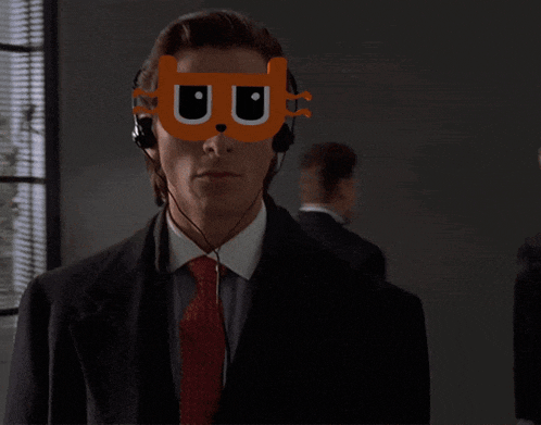 a man in a suit and tie has a mask on his face with the letter u on it